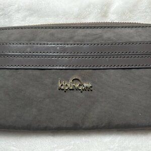 Beautiful EUC Kipling Zip Around Wallet in a Brownish Grey Color